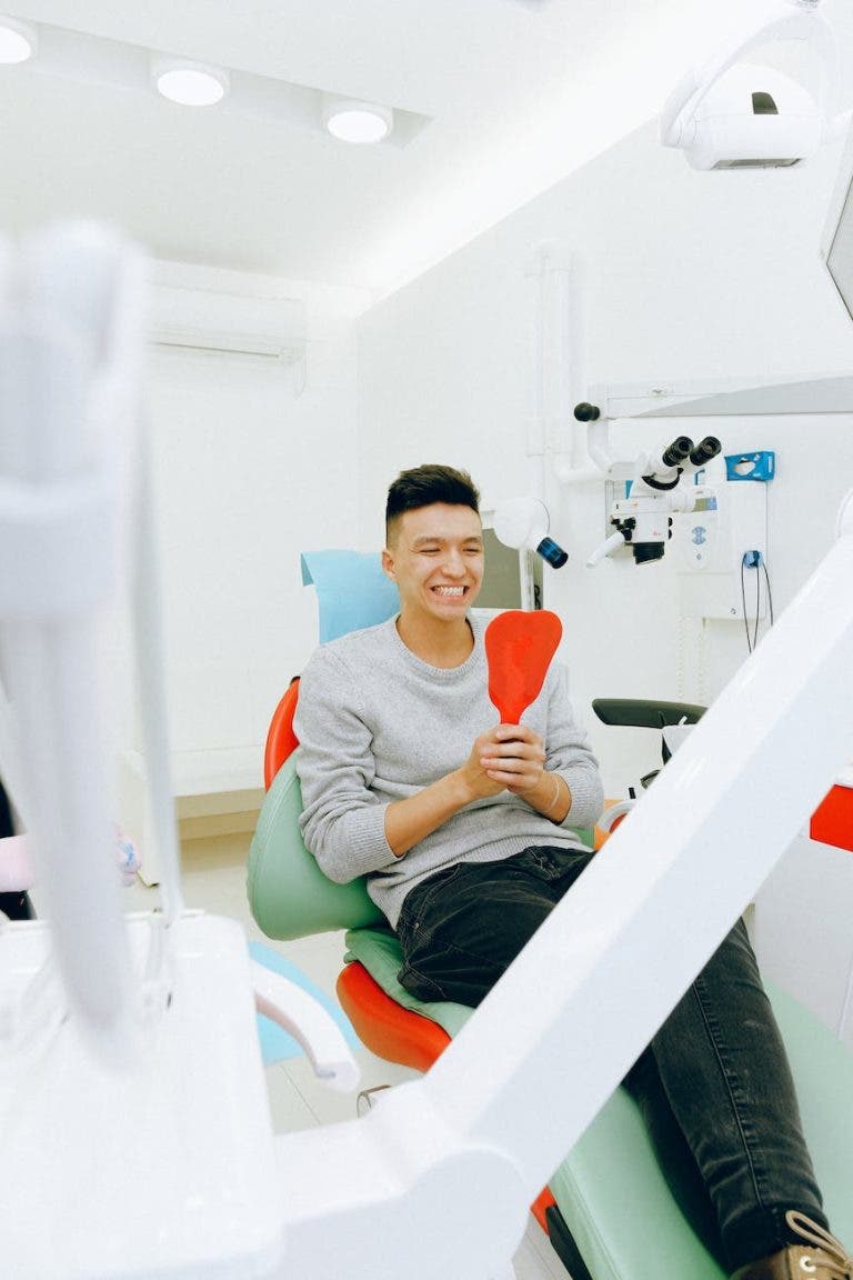 man sitting on dental chair