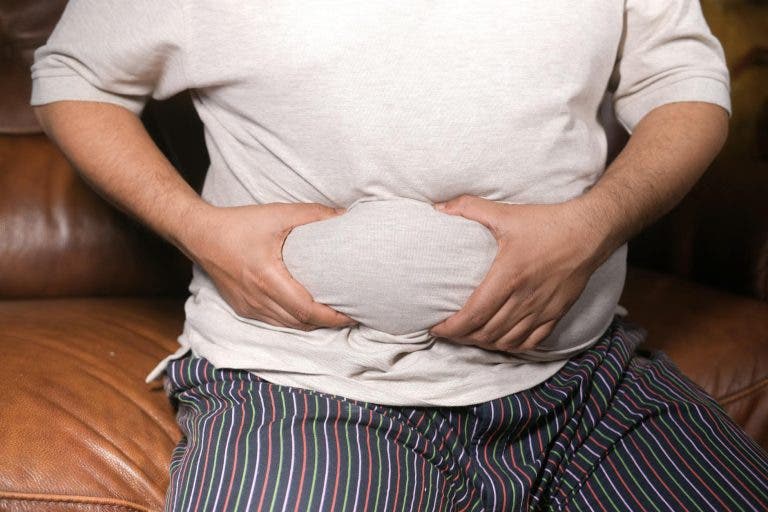 a man holding his tummy